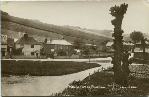 postcard showing a small green with houses behind