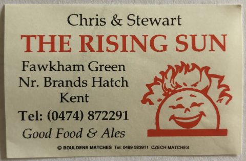 Matchbox cover from the Rising Sun Inn with picture of a sun rising with a comical face