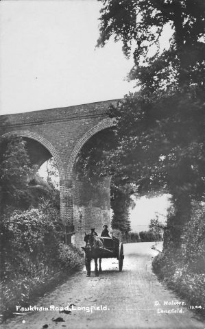 the railway bridge with a horse and cart driving under it in the 1900s