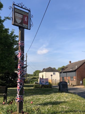 Village sign decorated with Union Jack bunting