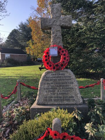 War memorial stone cross with poppy wreath